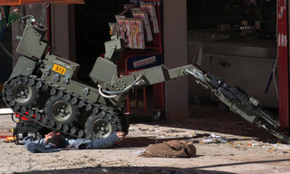 Illustration for article titled Photos of Robot Cleaning Up After Suicide Bomber: Reality Checks Are Often Disturbing
